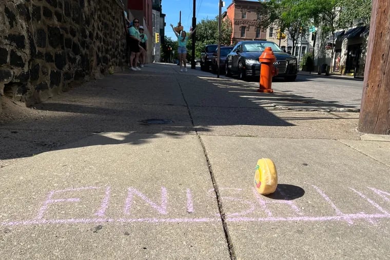 A wheel of cheese crosses the finish line at the 3rd Annual Cheese Roll Day Saturday in Philadelphia.