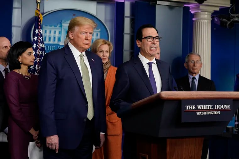 Treasury Secretary Steven Mnuchin speaks during a press briefing with the coronavirus task force, at the White House, Tuesday, March 17, 2020, in Washington, as President Donald Trump looks on.