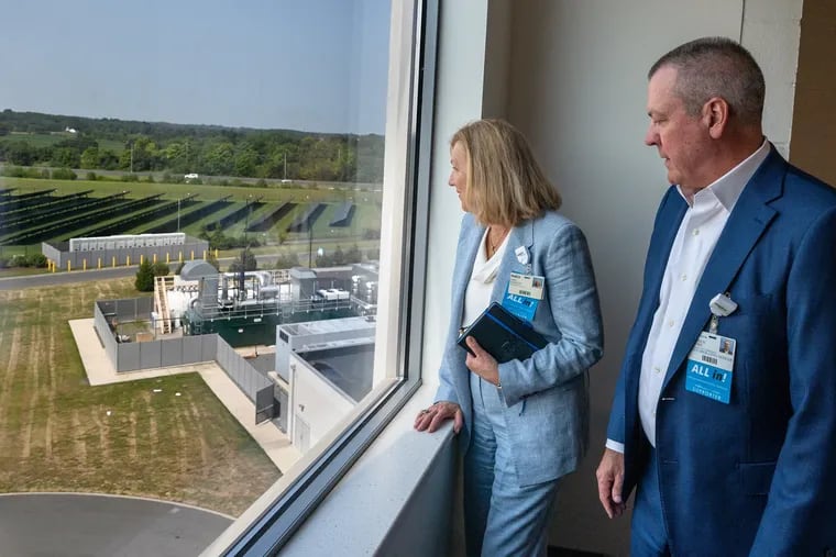 Inspira Health CEO Amy Mansue (left) and chief operating officer Warren Moore look toward an area outside where construction will soon begin on an expansion of their Inspira Medical Center in Mullica Hill.