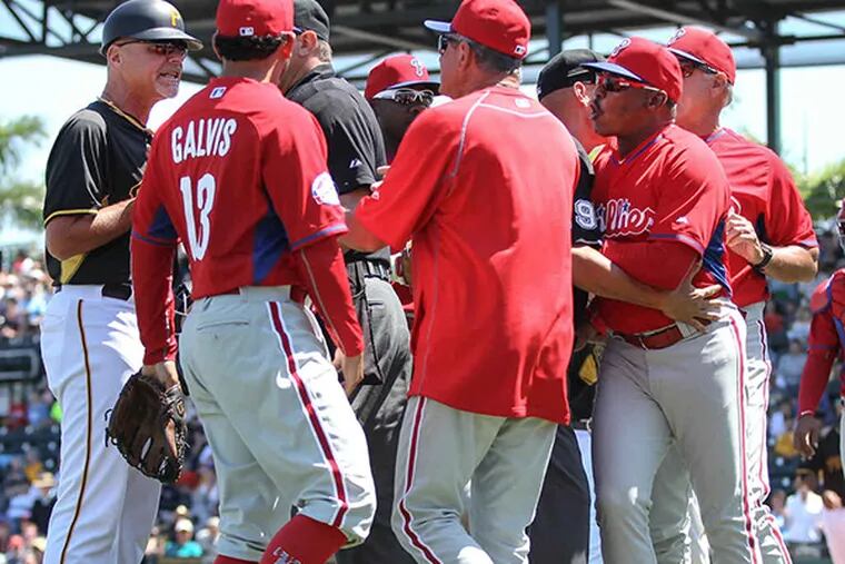 Phillies' first base coach Juan Samuel, right argues with Pirates' third base coach Rick Sofield, left causing them both to get tossed during the 5th inning at McKechnie Field in Bradenton Florida, Monday, March 30, 2015.  Phillies get beat by the Pirates 18-4. (Steven M. Falk/Staff Photographer)