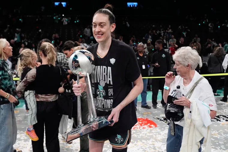 Breanna Stewart holds the WNBA championship trophy after playing a big role in the New York Liberty finally winning their first title.