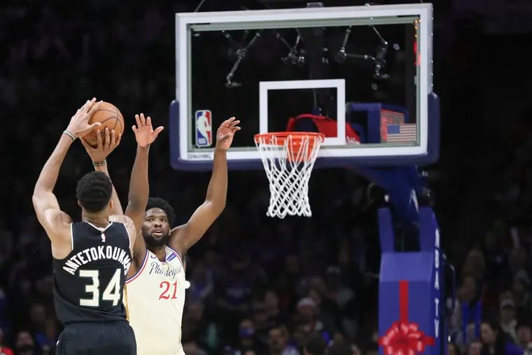 Joel Embiid defends Giannis Antetokounmpo during a 2019 game at the Wells Fargo Center.