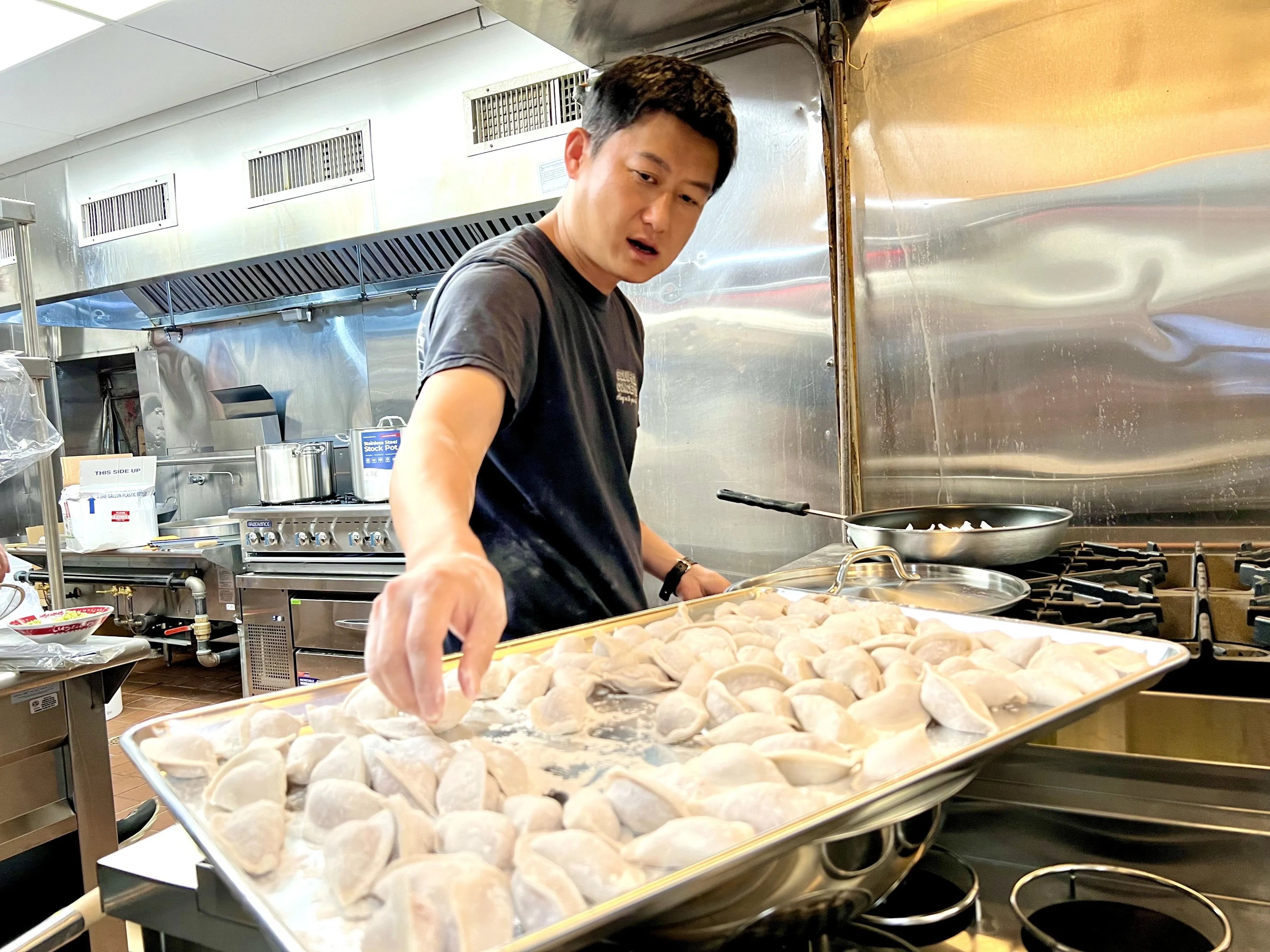 Luscious Dumplings owner Ker Zhu cooking dumplings at the restaurant, 937-939 Race St., on June 13, 2024.