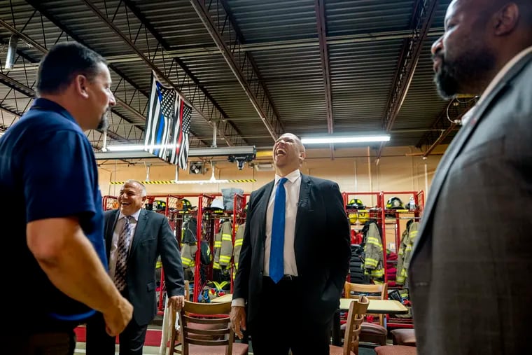 U.S. Sen. Cory Booker meets local elected officials and firefighters at the firehouse in Clayton, N.J., on Tuesday. The Democratic senator from Newark toured South Jersey during the Senate's summer recess.