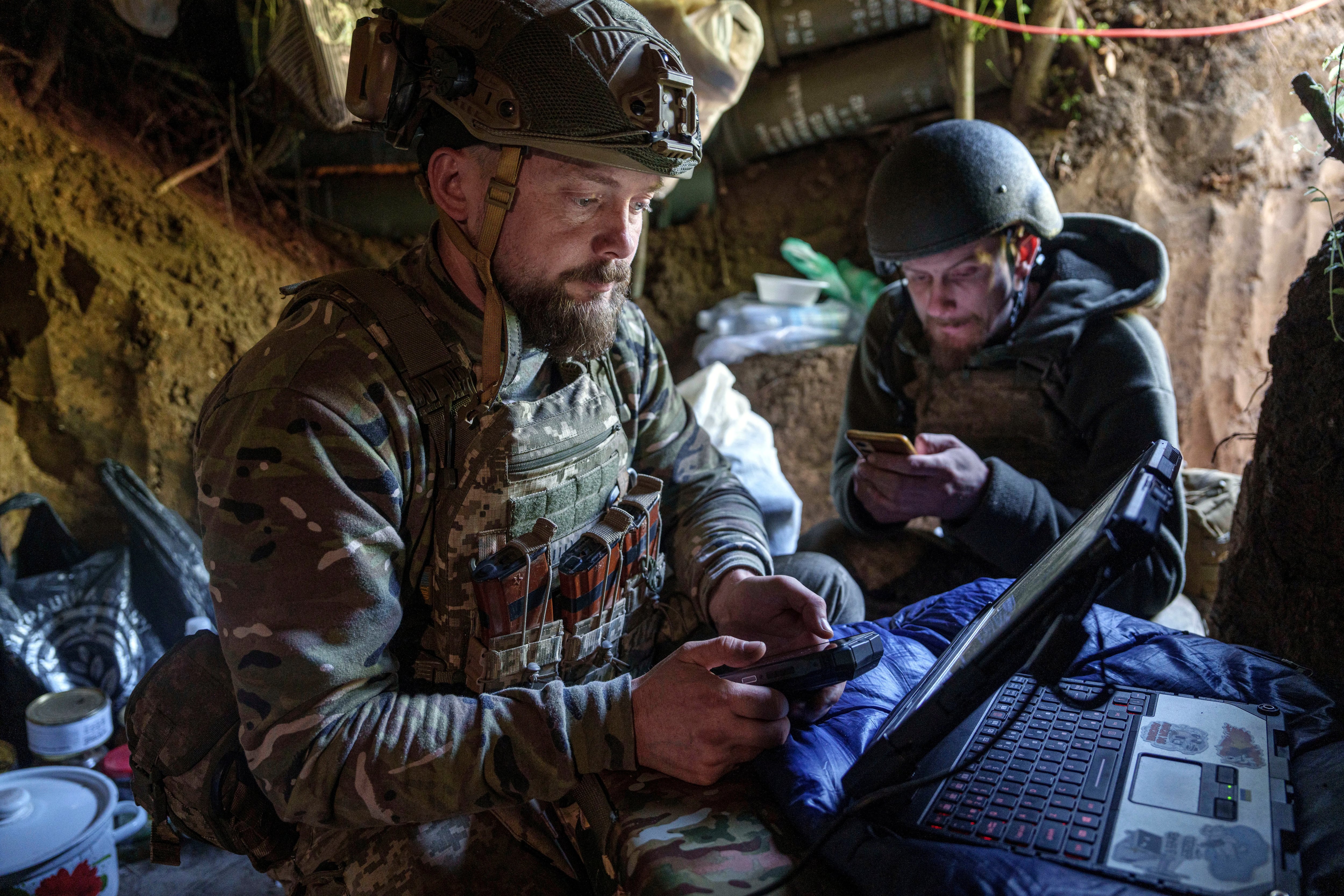 Ukrainian serviceman Andrii (left), of the Air Assault Forces 148th separate artillery brigade, sends receiving coordinates for a Furia drone at the front line in Donetsk region, Ukraine, in May.