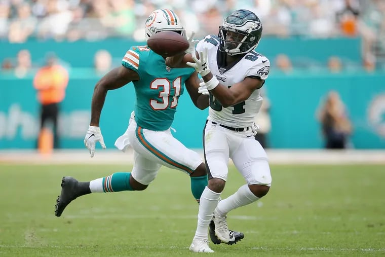Eagles wide receiver Greg Ward (84) makes a catch in front of Miami Dolphins cornerback Ken Webster on Dec. 1.