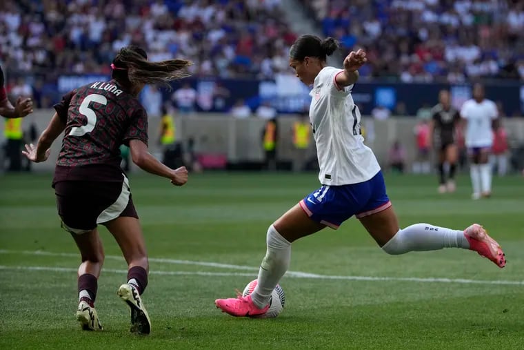 Sophia Smith (right) lines up the shot that she scored from during Saturday's game.