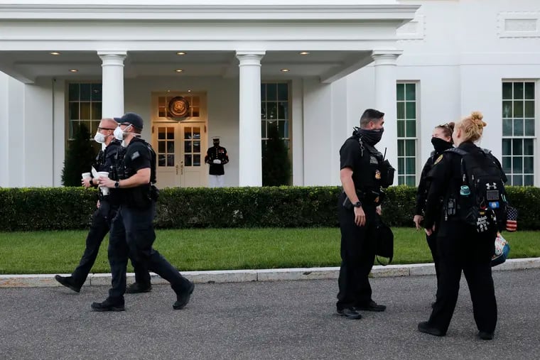 A Marine and members of the Secret Service were outside the West Wing while President Donald Trump was in the Oval Office of the White House on Oct. 8.