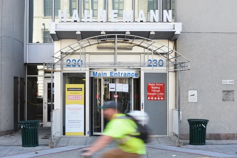 The main entrance of Hahnemann University Hospital with a closed sign on the window located at Broad and Vine Streets.