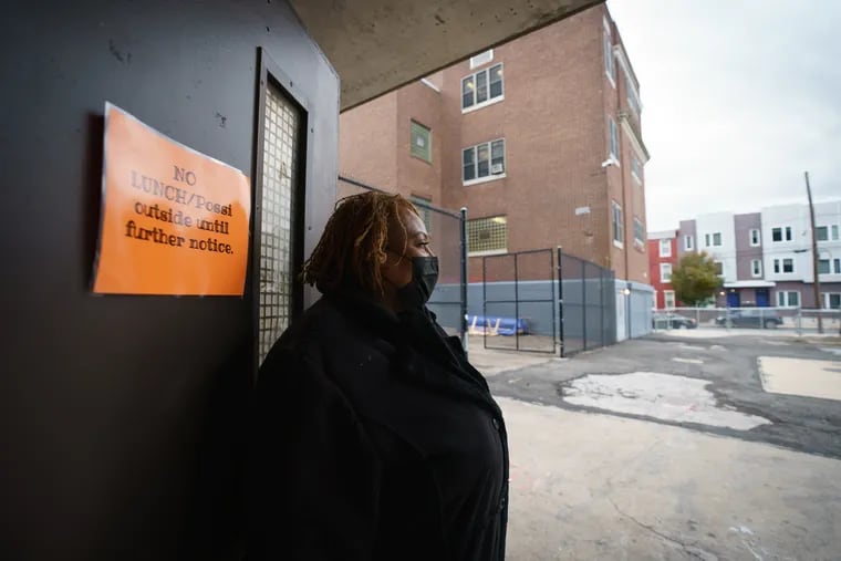 Paula Crawford stands in the doorway that leads to the school yard at the U School, a Philadelphia public high school. Gun violence in the neighborhood has colored the school year for students and staff, said Crawford, a school counselor.