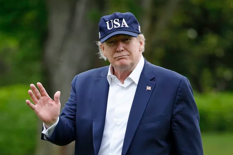 President Donald Trump walking on the South Lawn of the White House after stepping off Marine One on Sunday.