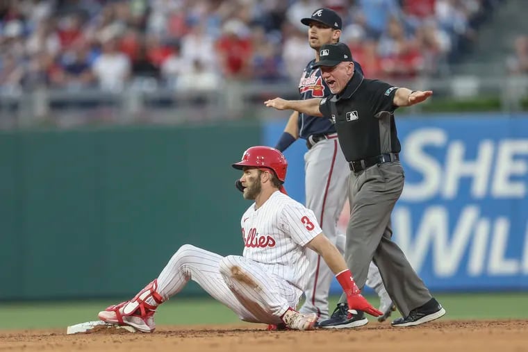 Phillies outfielder Bryce Harper falls back to second after hitting a double in the third inning Friday against Atlanta.