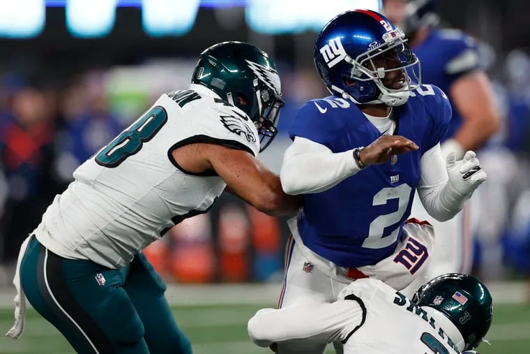 Eagles linebackers Nolan Smith and Patrick Johnson pressure Giants quarterback Tyrod Taylor on Sunday. The Birds dropped their regular-season finale and will play the Tampa Bay Buccaneers on Monday.