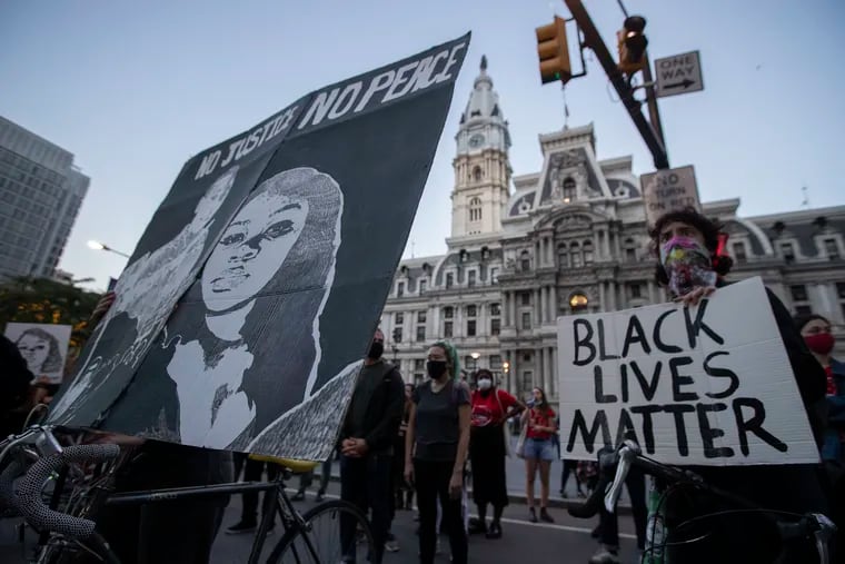 Protesters gather at City Hall after a Kentucky grand jury announced on Sept. 23, 2020 an indictment against one officer six months after the death of Breonna Taylor. Breonna is featured on the poster on left.