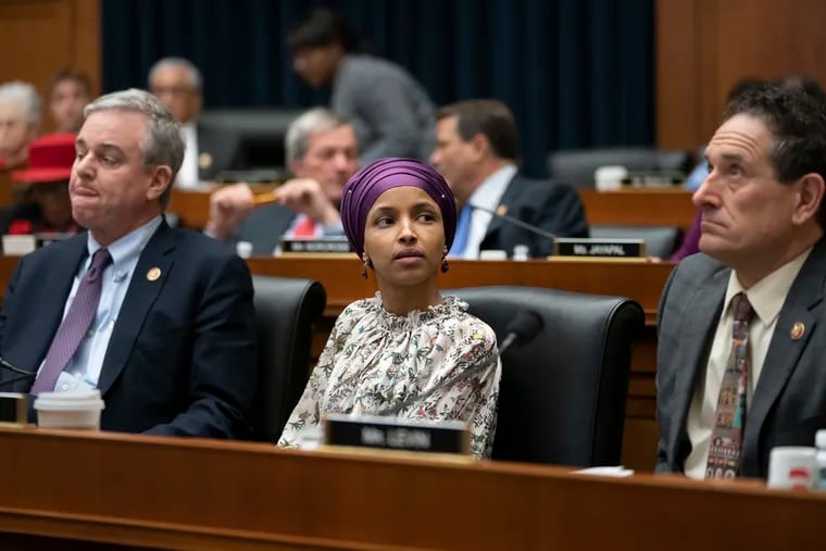 Rep. Ilhan Omar, D-Minn., sits with fellow Democrats, Rep. David Trone, D-Md., left, and Rep. Mike Levin, D-Calif., right, on the House Education and Labor Committee during a bill markup in Washington, March 6, 2019. Omar stirred controversy last week with comments about Israel and U.S. policy, prompting the House to draft a resolution this week condemning anti-Semitism.