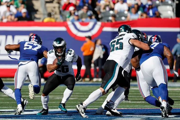 Eagles running back Saquon Barkley runs past New York Giants linebacker Patrick Johnson during the third quarter on Sunday.