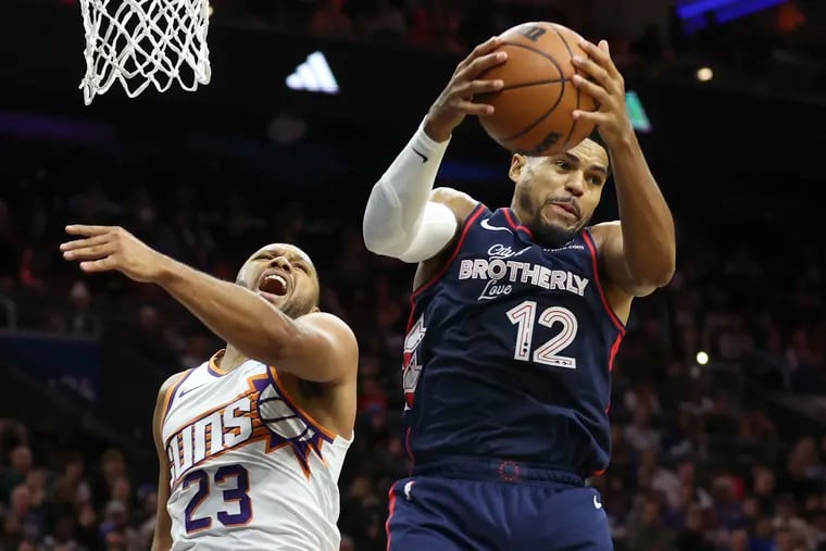 Phoenix Suns guard Eric Gordon fighting for a rebound against the Sixers'  Tobias Harris on Nov. 4, 2023.