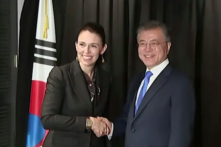 In this image made from a video, New Zealand's Prime Minister Jacinda Ardern, left, and South Korean President Moon Jae-in  shake hands in Auckland, New Zealand Tuesday, Dec. 4, 2018. Ardern says New Zealand will soon allow smoother immigration procedures for visitors from South Korea and plans to improve pension portability between the two countries. (NZ POOL via AP)