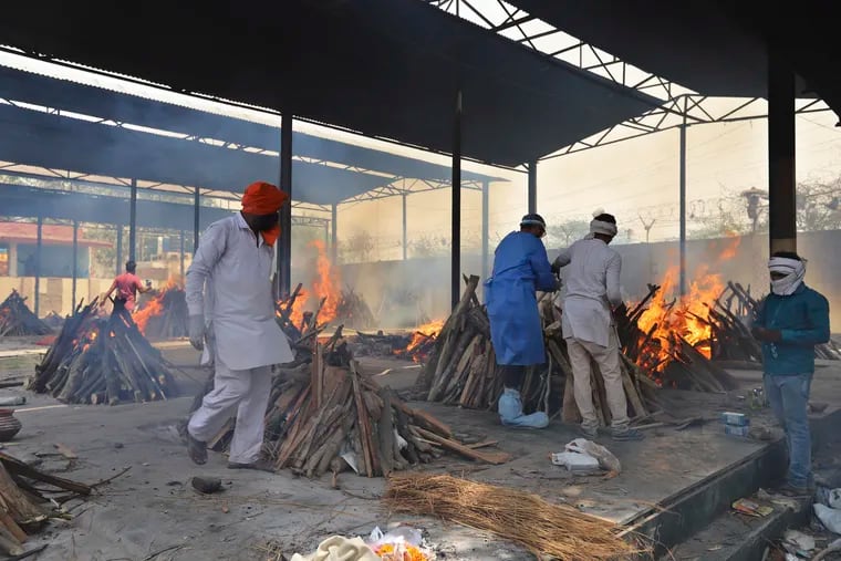 Multiple funeral pyres of COVID-19 victims burn as relatives perform last rites at a crematorium in New Delhi, India, Friday, April 30, 2021. Indian scientists appealed to Prime Minister Narendra Modi to publicly release virus data that would allow them to save lives as coronavirus cases climbed again Friday, prompting the army to open its hospitals in a desperate bid to control a massive humanitarian crisis.