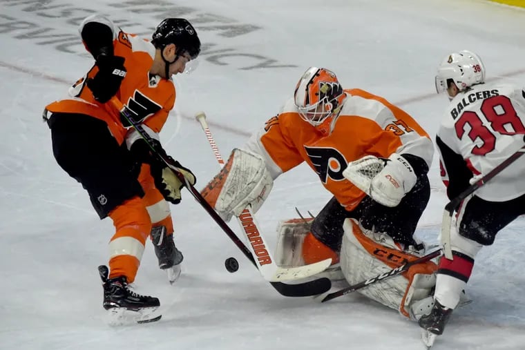 Flyers goaltender Brian Elliott and Shayne Gostisbehere (left) defend the net against Ottawa in a file photo. Elliott will face New Jersey on Tuesday and Gostisbehere could make his season debut.