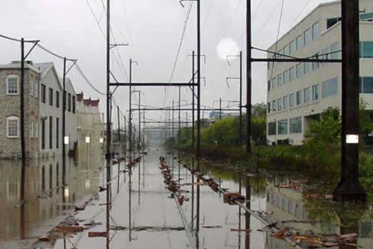 Regional Rail tracks lie underwater near Conshohocken Station after Tropical Storm Tammy struck in 2005. A shoreline stabilization project will buttress the Schuylkill riverbank in flood-prone areas on the Manayunk/Norristown Line. (Courtesy of SEPTA)