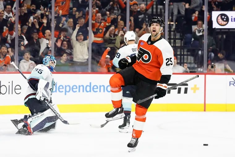 Flyers center Ryan Poehling celebrates his first period short handed goal past Kraken goaltender Joey Daccord and defenseman Vince Dunn.