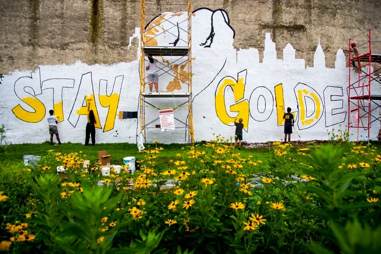 Artists work on the "Stay Golden" mural in Strawberry Mansion July 25, 2020.