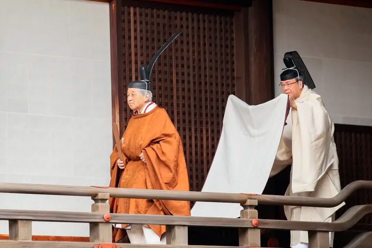 Japan's Emperor Akihito (left) walks for a ritual to report his abdication to the throne, at the Imperial Palace in Tokyo, Tuesday, April 30, 2019. The 85-year-old Akihito ends his three-decade reign on Tuesday when he abdicates to his son Crown Prince Naruhito. (Japan Pool via AP)