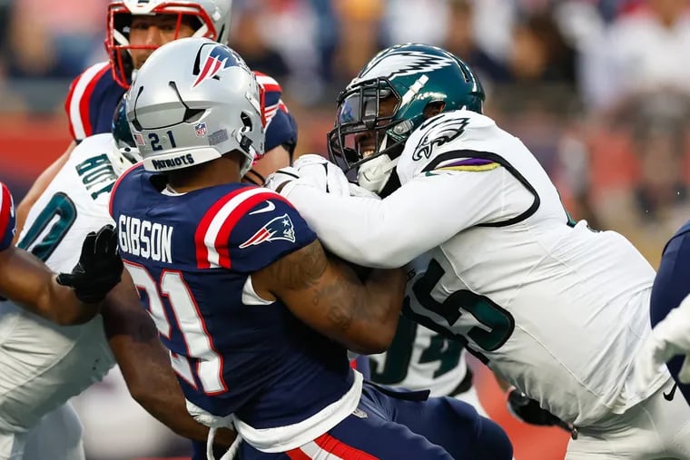 Philadelphia Eagles defensive tackle Marlon Tuipulotu goes after New England Patriots running back Antonio Gibson in the first quarter, Thursday, Aug. 15, 2024, in Foxborough, Mass.