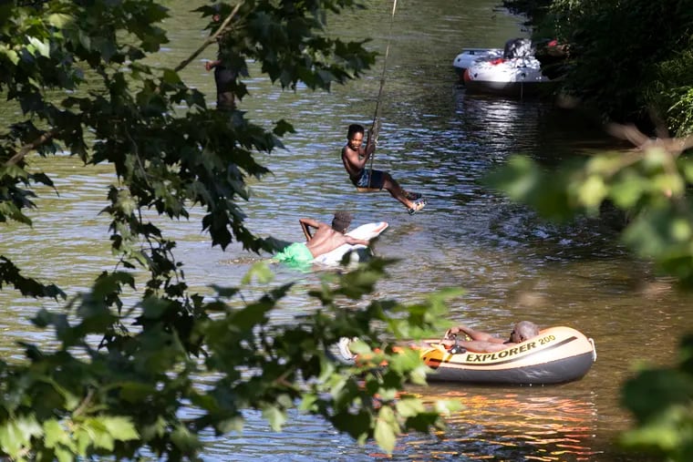 People cool off in the West Branch of the Brandywine River in at the ChesLen Preserve in Newlin Township, Chester County on July 23, 2022.
