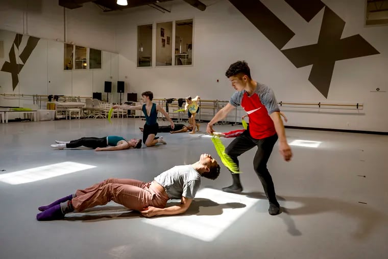 Mathis Joubert (on floor), Jared Kelly (standing), and other BalletX dancers rehearse “Macaroni” for the company's summer series at their studio in South Philadelphia, June 17, 2024.