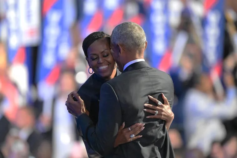 Barack and Michelle Obama embrace as the former president takes the stage Tuesday at the Democratic National Convention in Chicago.