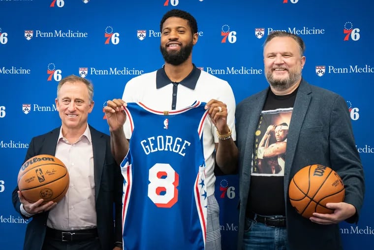 (Left to RIght) Josh Harris, Paul George and Daryl Morey, shown here during George's introduction press conference on Tuesday.
