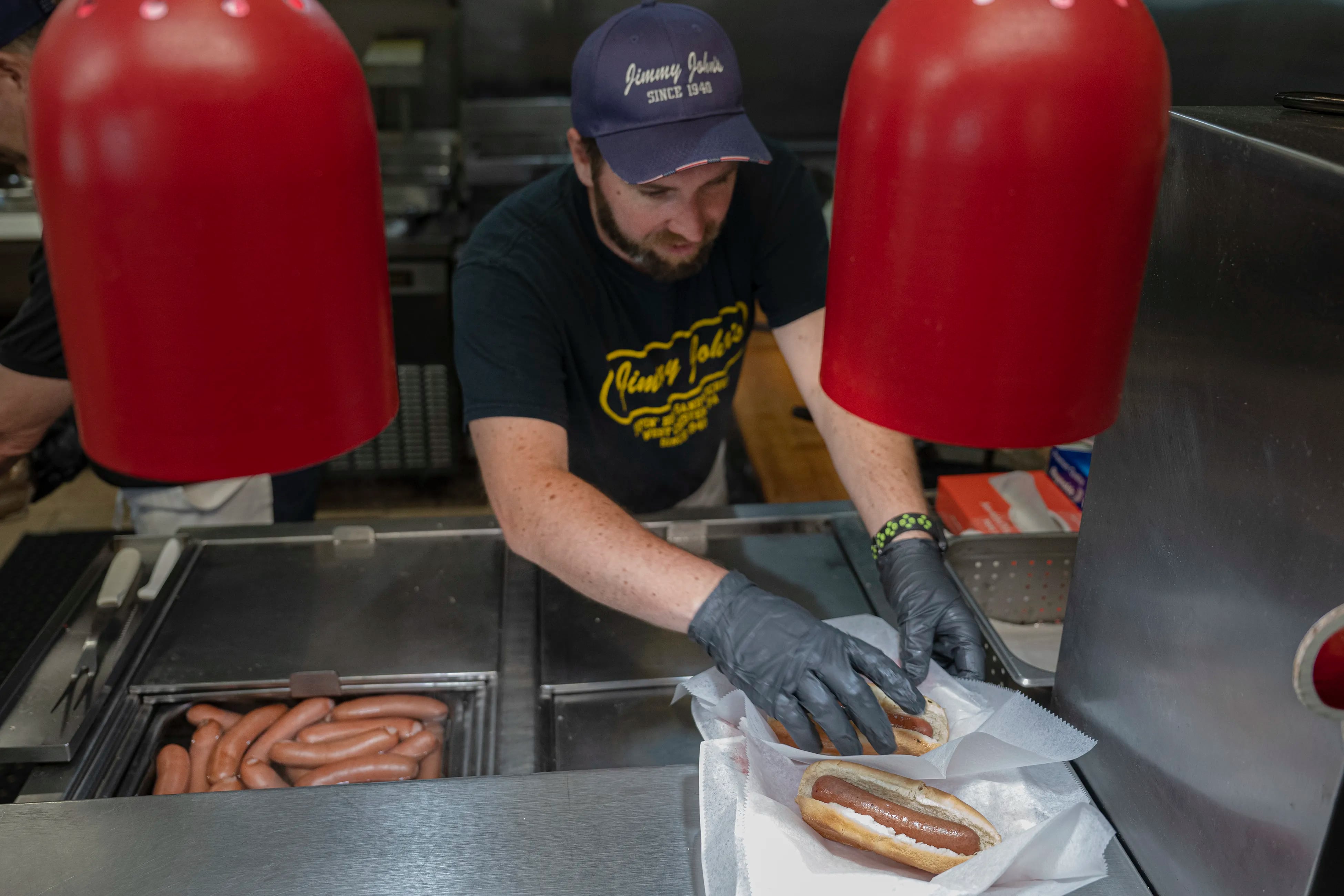 Roger Steward prepares hot dogs on Friday, July 12, 2024 at Jimmy John's Pipin' Hot Sandwiches in West Chester, Pa. The original Jimmy John's — open since 1940 — specializes in frankfurters.