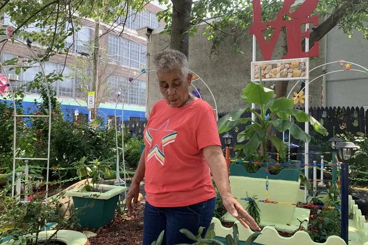 Iris Rodríguez tends to the community garden she helped form five years ago at Mascher and Dauphin Streets. The land is not hers, and she fears it could be snatched up for development.