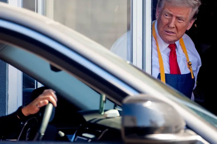 Former President Donald Trump works the drive-thru window at the McDonald’s in Feasterville, Bucks County, on Sunday.