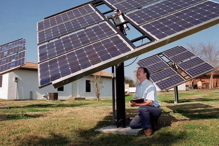 Institute of Food and Agricultural Sciences energy extension specialist Wendell Porter checks one of three passive solar trackers outside a demonstration house at the University of Florida Thursday, March 2, 2000. The 24 solar panels in the trackers provide enough electricity to completely power the 900-square-foot house behind Porter, including air conditioning, heat, lights and computers. The trackers use the heat from the sun to keep the panels pointed at the sun throughout the day. Porter said the house was built to demonstrate that a typical house can be powered primarily by solar power using off-the-shelf components. (AP Photo/University of Florida/IFAS, Eric Zamora)