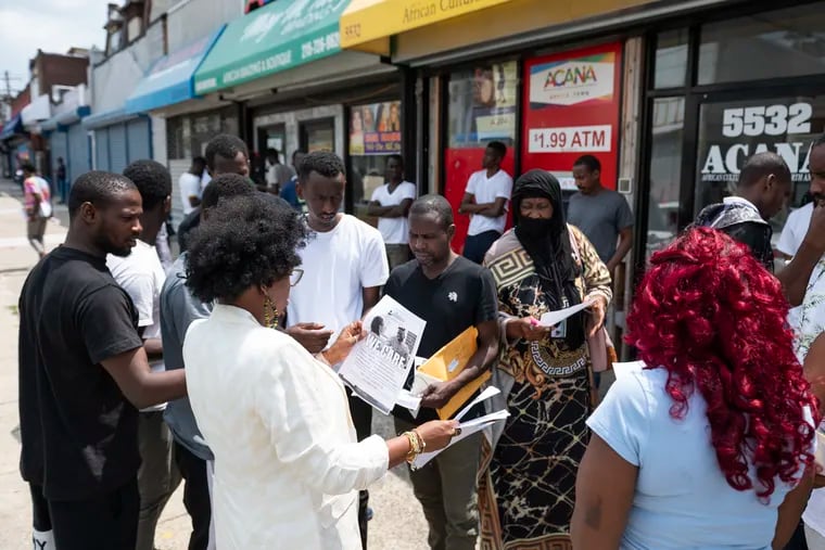 The West Philadelphia Community Mental Health Consortium hands flyers out to residents of Kingsessing on Chester Avenue on Wednesday, July 5, 2023.