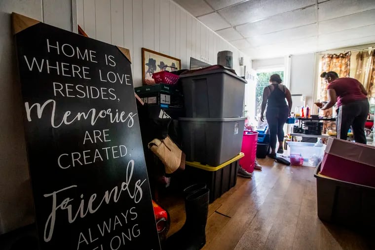 Antoinette Austin-Hunt, right and a friend work on cleaning and packing in her family's flood-damaged Bridgeport home on Sept. 7.
