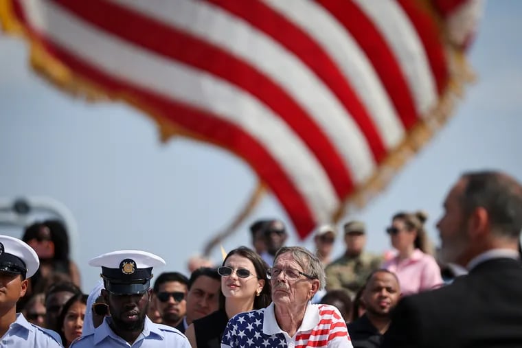 Bjorn Bedersen (right), who was one of the 42 soon-to-be new U.S. citizens, listened to a speech during an Independence Day Naturalization Ceremony on Battleship New Jersey in Camden, Camden.