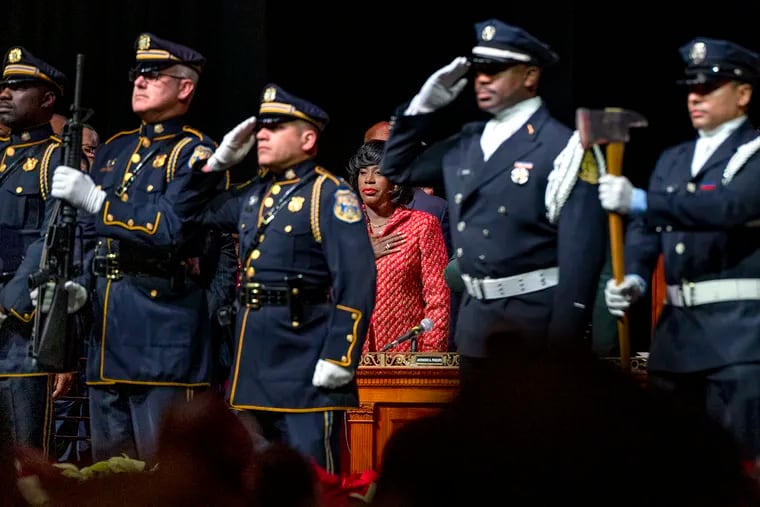 January 8. 2024: Mayor Cherelle L. Parker stands for the presentation of colors and the national anthem with the police and fire color guard, on stage at the Met Philadelphia on North Broad Street at the opening of her inauguration ceremony.