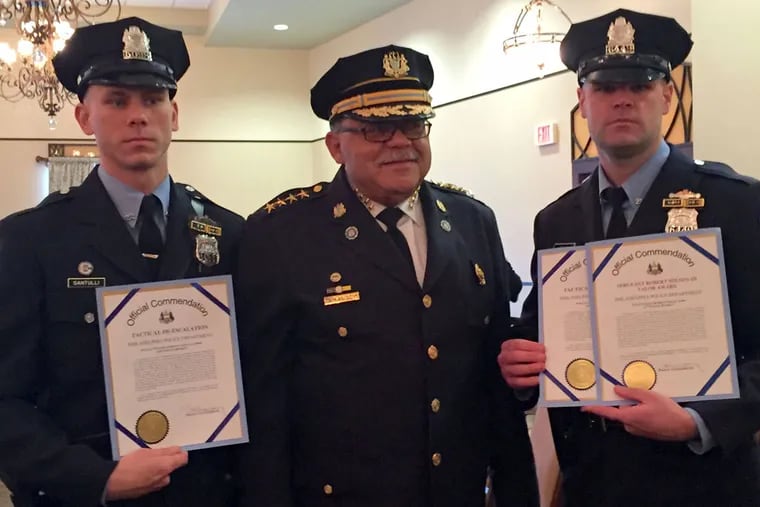 Officers Anthony Santulli (left) and Brian Nolan join Commissioner Charles Ramsey after receiving awards.