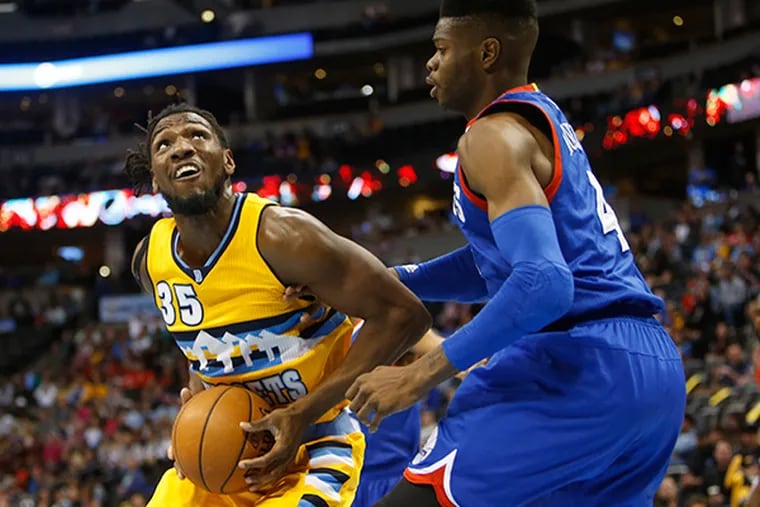 Denver Nuggets forward Kenneth Faried (35) looks to shoot against 76ers center Nerlens Noel (4) during the first half at Pepsi Center. (Chris Humphreys/USA Today)
