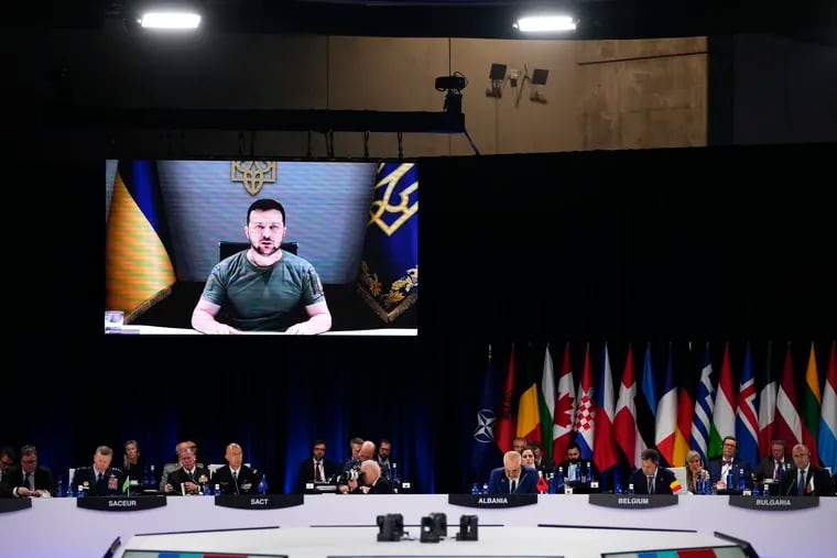 Ukraine's President Volodymyr Zelenskyy addresses leaders via a video screen during a round table meeting at a NATO summit in Madrid on Wednesday.