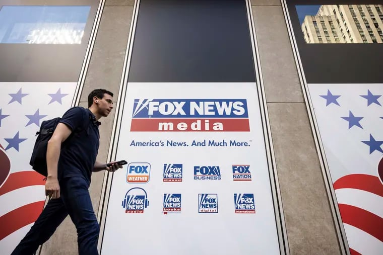 A person walks past the Fox News Headquarters in New York in April.