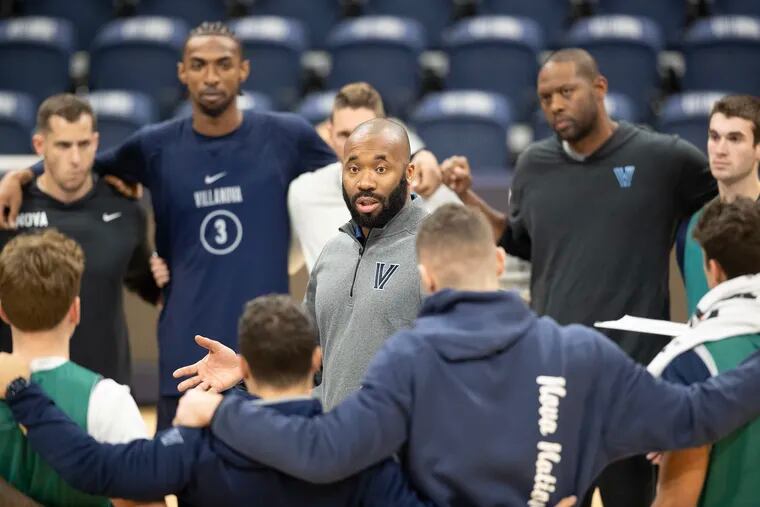 Villanova coach Kyle Neptune huddles with the Wildcats at the end of practice on  Oct. 19.