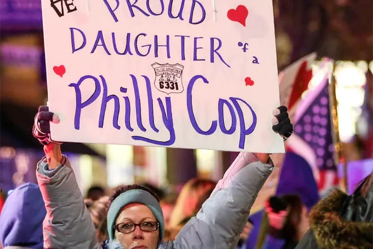 Stacey Birney, whose father had been a Philadelphia police officer. Some had signs that read, "Blue Lives Matter."
