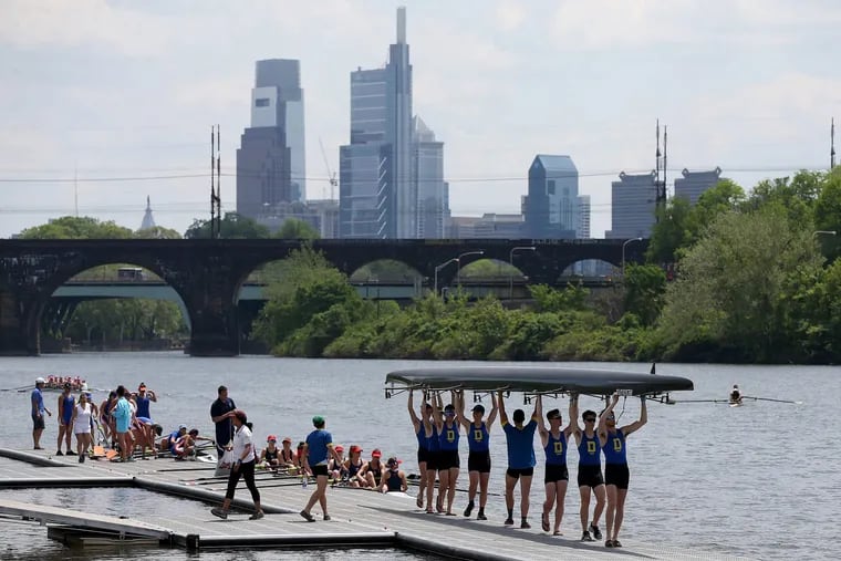 Delaware rowers carry their shell to the water during the annual Dad Vail Regatta on the Schuylkill on Friday, May 11, 2018. The event may not be able to continue on the Schuylkill unless the river is dredged.
