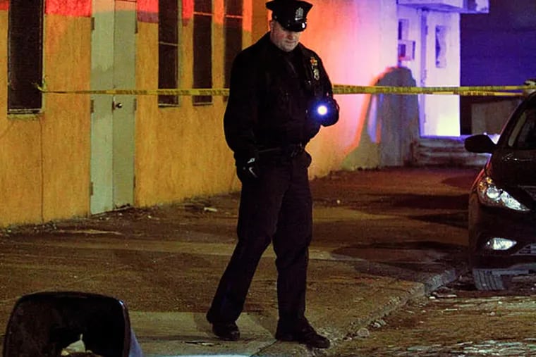 Police look for evidence on the 900 block of N. Front Street in the Northern Liberties section of Philadelphia on Sunday Jan. 19, 2013, after a woman was fatally wounded during a purse snatching. (For the Daily News/ Joseph Kaczmarek)