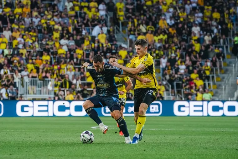 Dániel Gazdag (left) keeps the ball away from Columbus' Sean Zawadzski (right) during the first half.